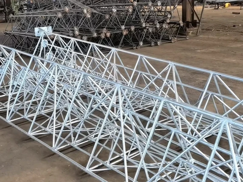 Galvanized lattice tower sections ready for inspection
