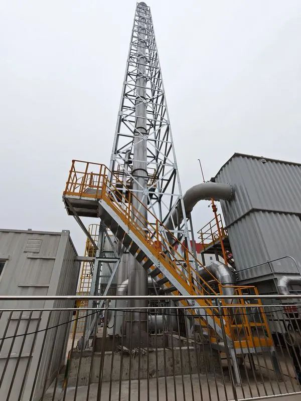 Galvanized chimney support tower with yellow access stairs and flue elbows