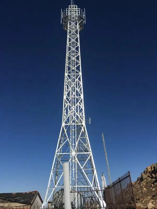 Four-leg self-supporting communication tower with top antenna platform on a rocky hilltop