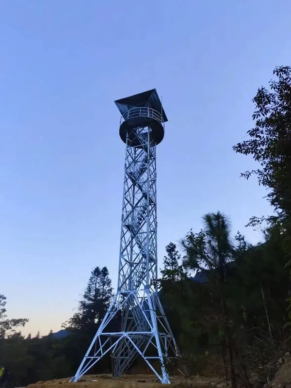 Four-leg galvanized steel observation tower above a pine forest