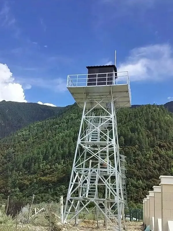 Steel lookout tower with an enclosed black observation cabin