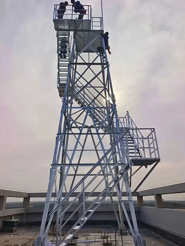 Workers assembling a galvanized observation tower on a rooftop