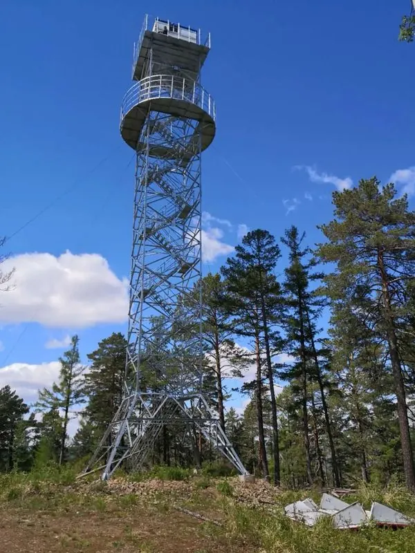 Tall galvanized observation tower with a circular viewing deck